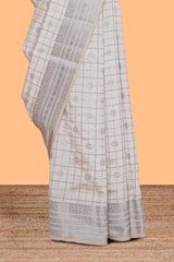 Off white checked zari design raw silk saree with self zari border and matching striped blouse
