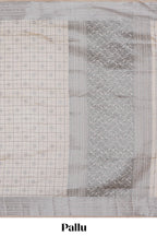 Off white checked zari design raw silk saree with self zari border and matching striped blouse