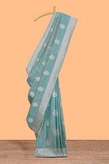 Green floral zari design raw silk saree with self zari border and matching motifs blouse