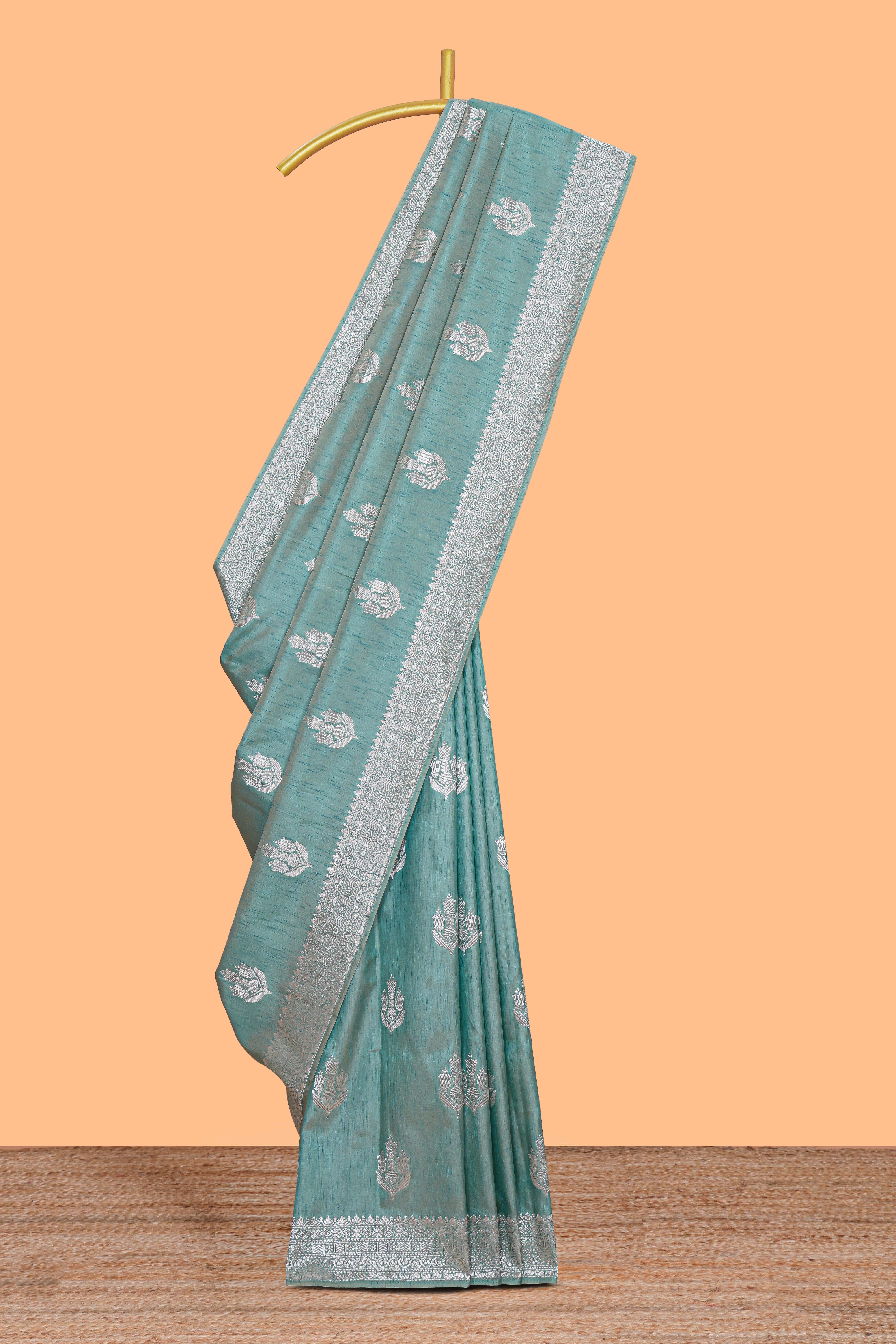Green floral zari design raw silk saree with self zari border and matching motifs blouse