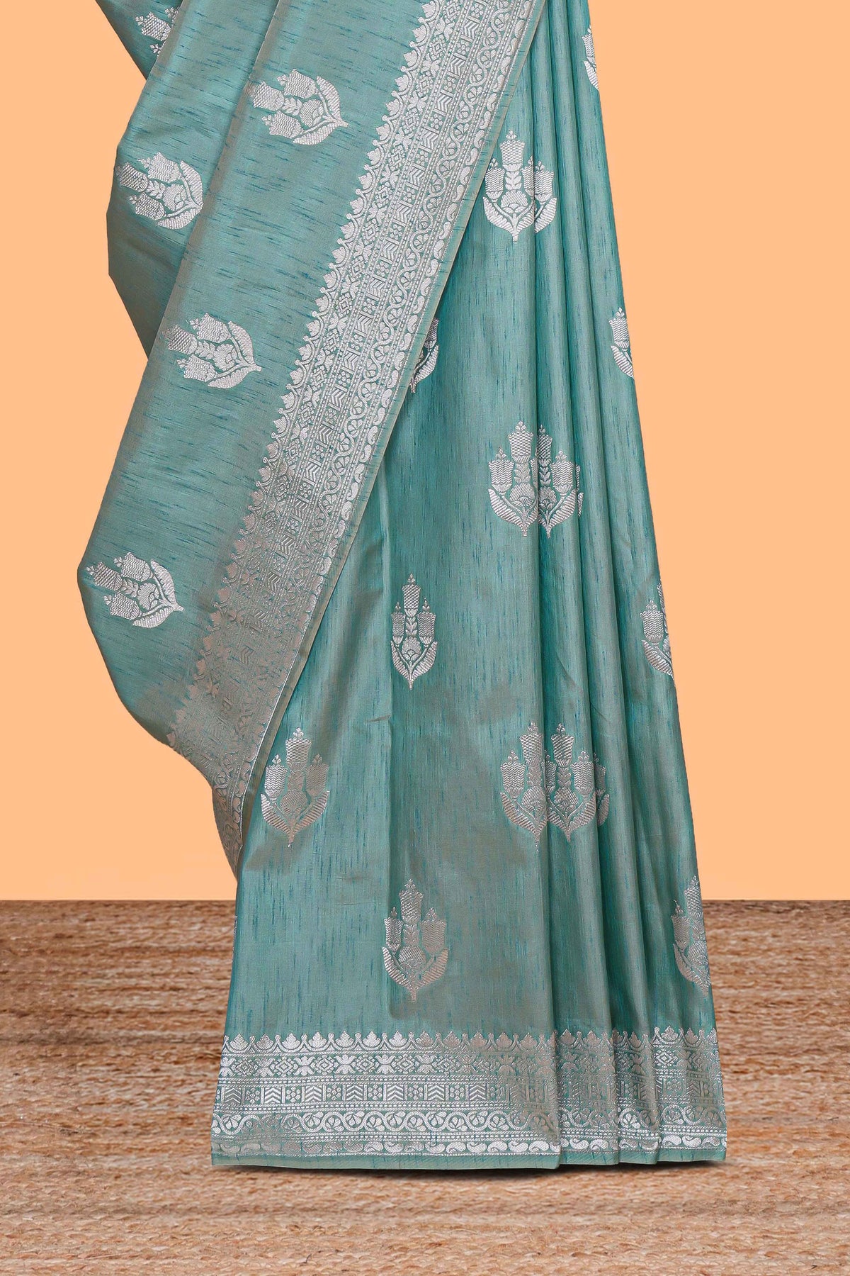 Green floral zari design raw silk saree with self zari border and matching motifs blouse