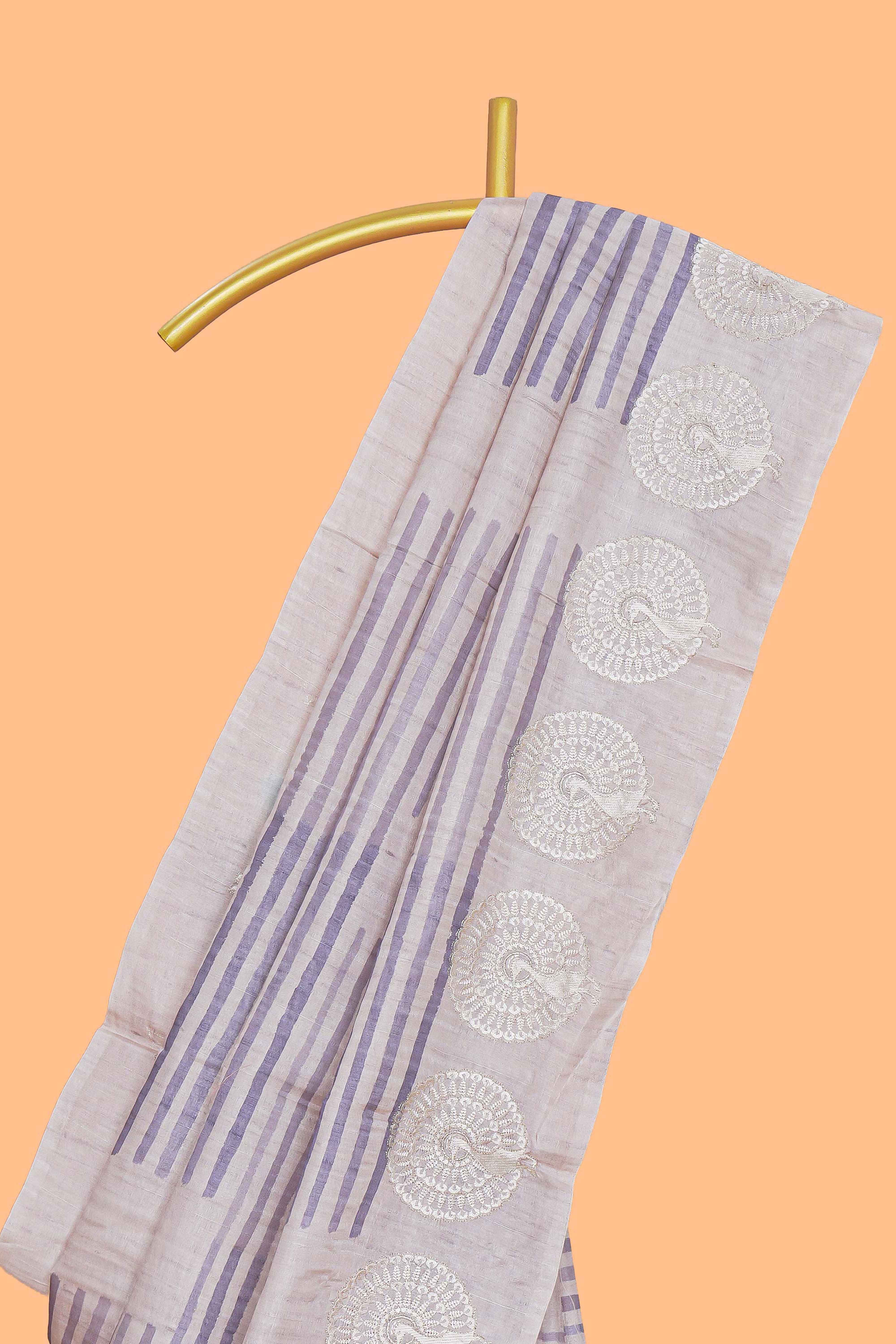 Off white striped design raw silk saree with self peacock design embroidery border and matching checked blouse