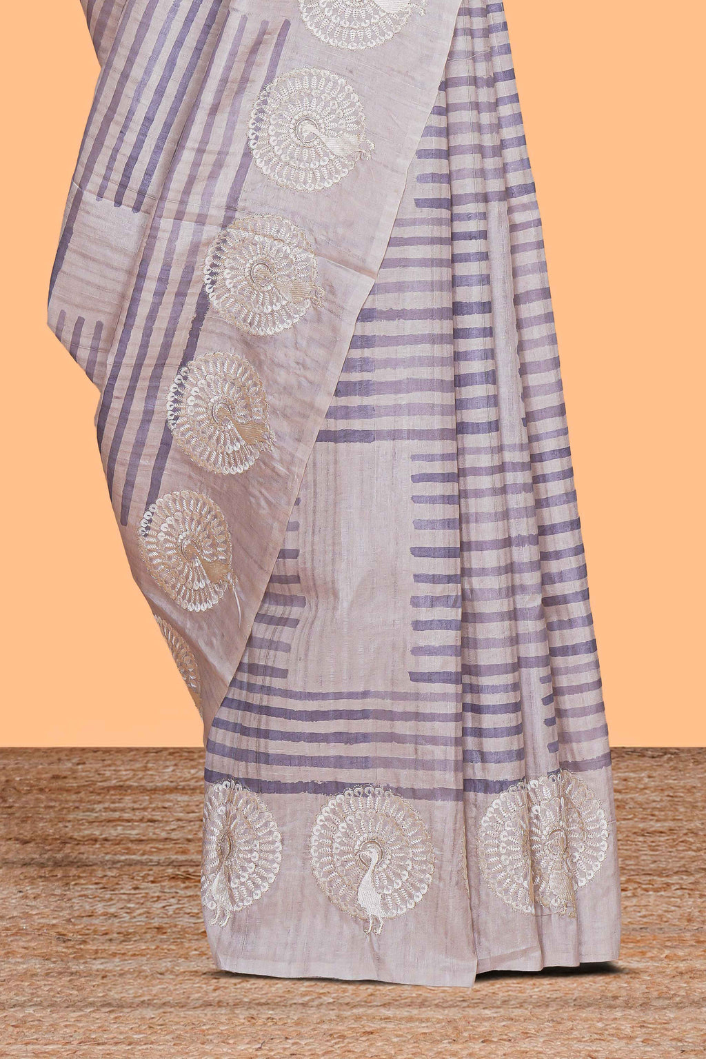 Off white striped design raw silk saree with self peacock design embroidery border and matching checked blouse