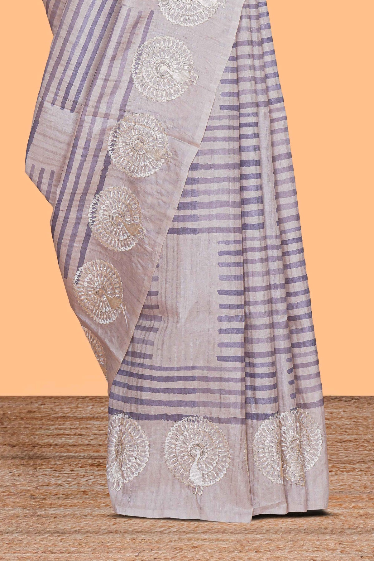 Off white striped design raw silk saree with self peacock design embroidery border and matching checked blouse