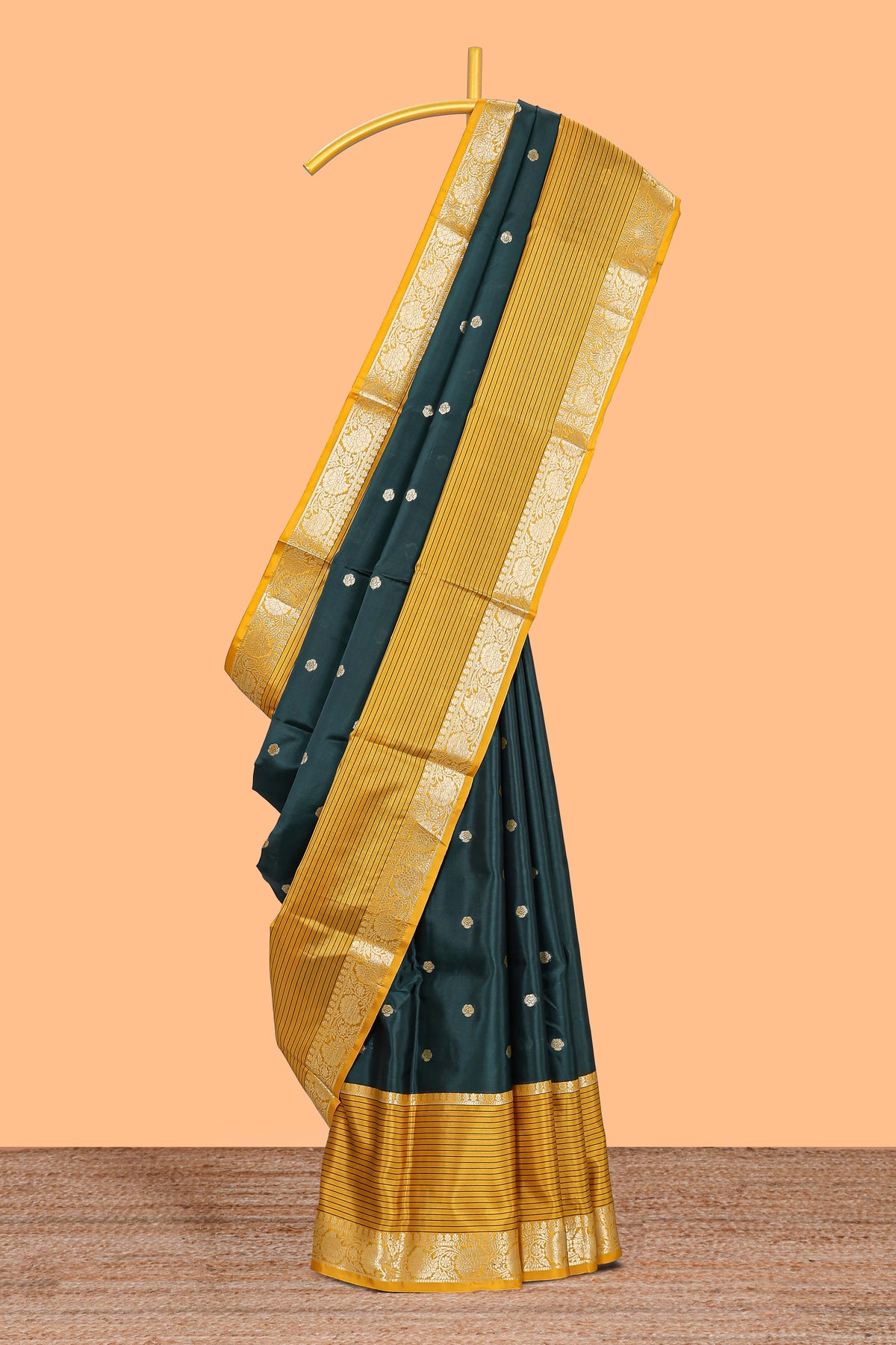 Green butta designed raw silk saree with contrast border and blouse