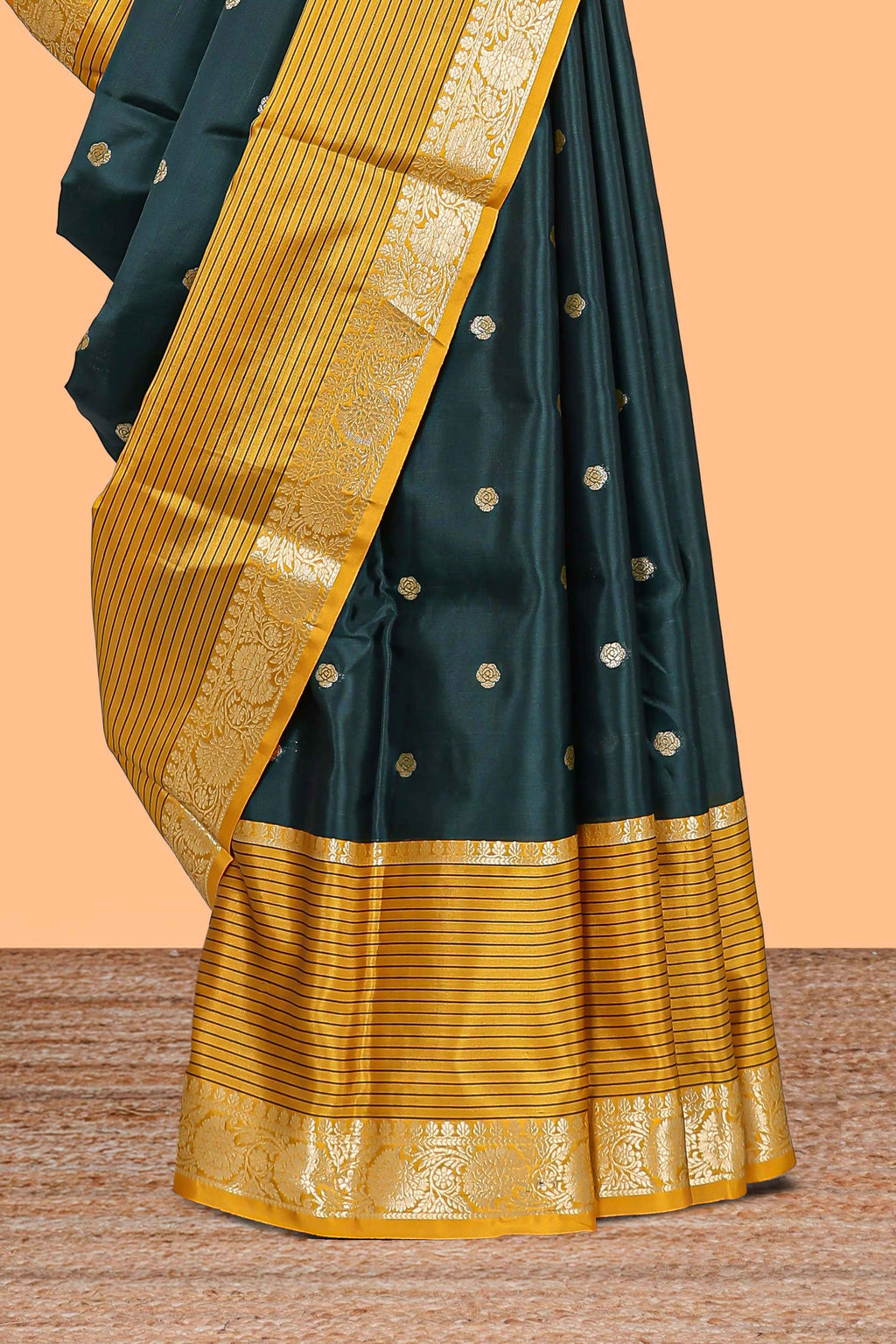 Green butta designed raw silk saree with contrast border and blouse