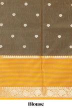 Green butta designed raw silk saree with contrast border and blouse