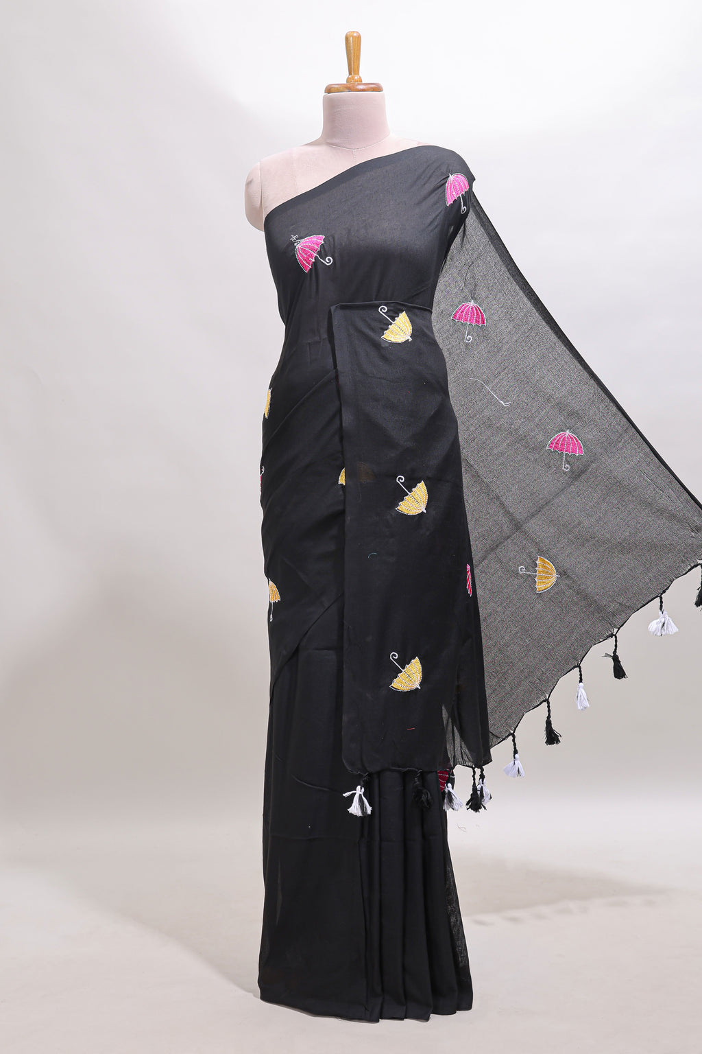 Borderless black umberla motifs design saree with contrast blouse and tassels