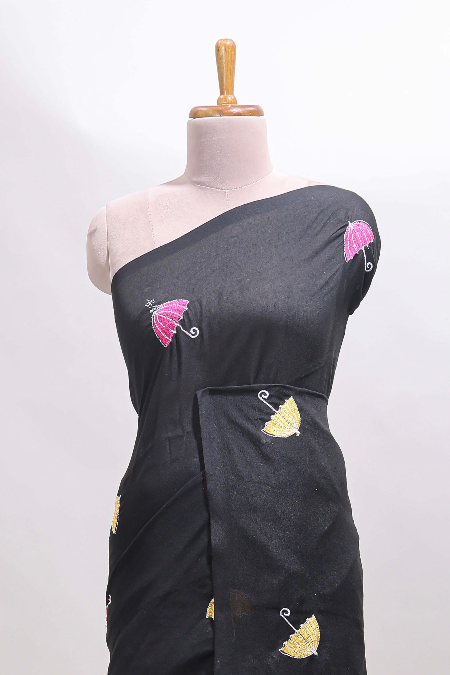 Borderless black umberla motifs design saree with contrast blouse and tassels