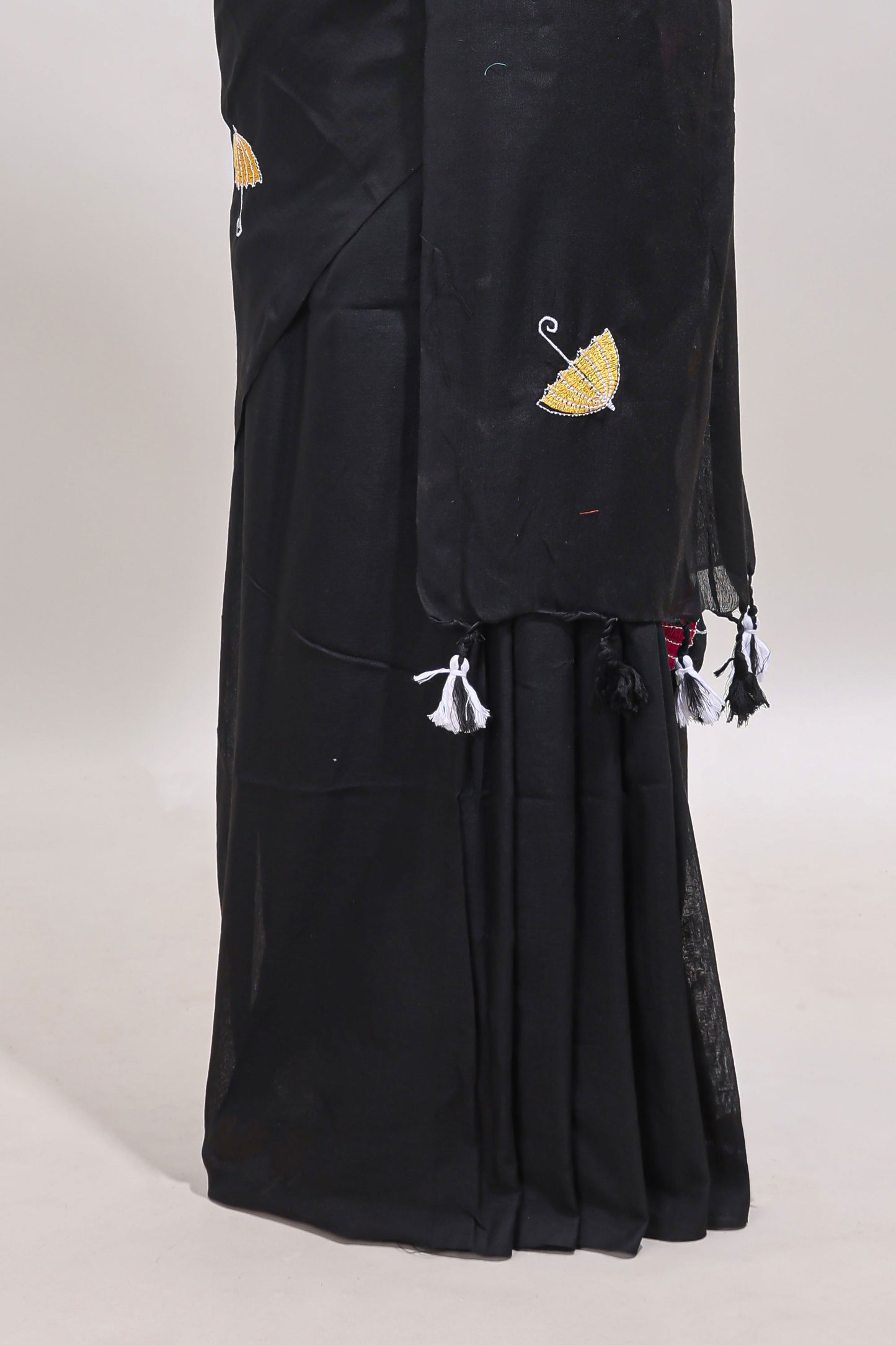 Borderless black umberla motifs design saree with contrast blouse and tassels