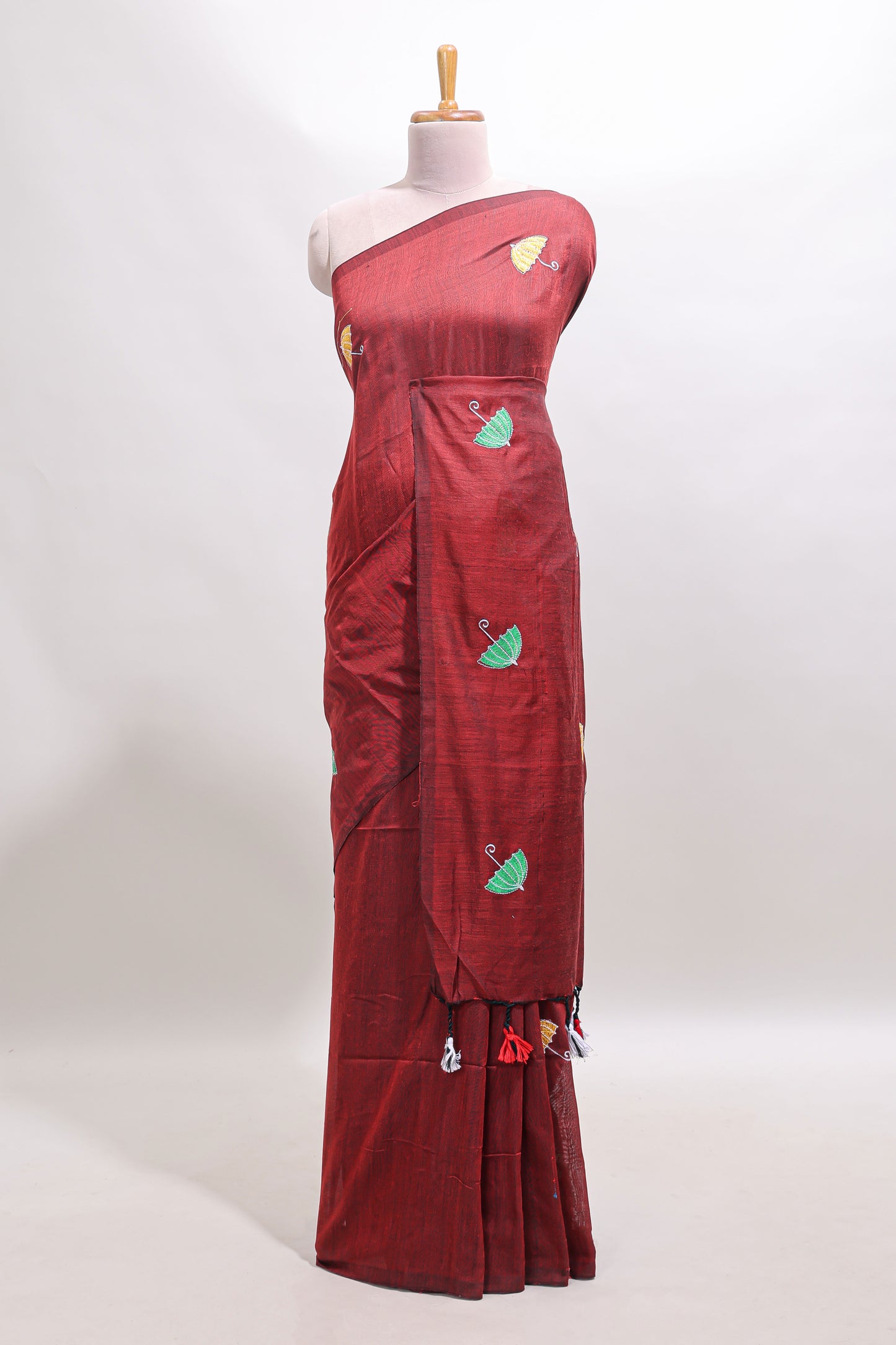 Borderless maroon umberla motifs design saree with contrast blouse and tassels