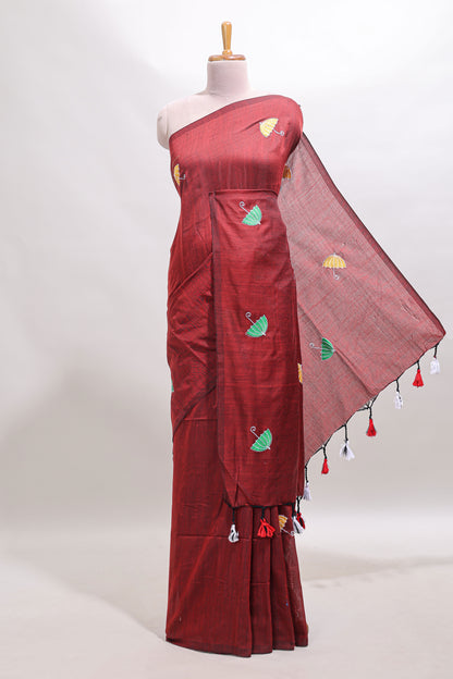 Borderless maroon umberla motifs design saree with contrast blouse and tassels