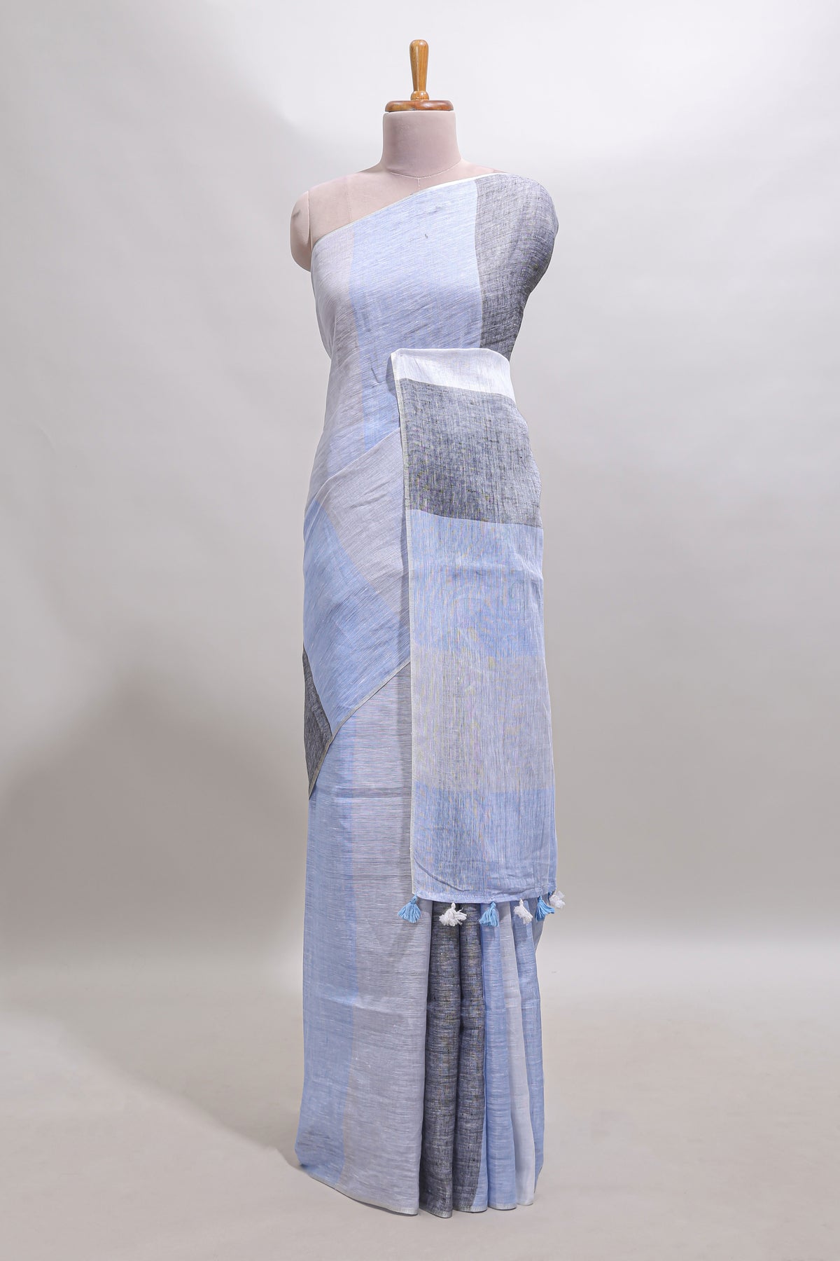 Light sky blue south cotton saree body with broad grey contrast borders and a matching striped pallu finished with tassels with a matching blouse piece