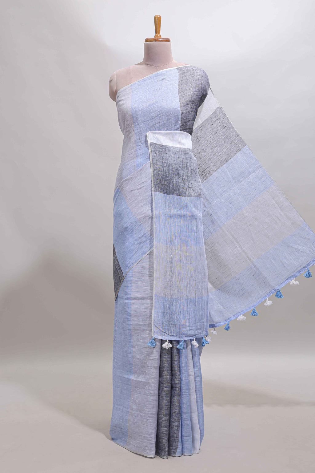 Light sky blue south cotton saree body with broad grey contrast borders and a matching striped pallu finished with tassels with a matching blouse piece
