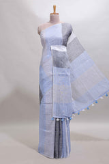Light sky blue south cotton saree body with broad grey contrast borders and a matching striped pallu finished with tassels with a matching blouse piece