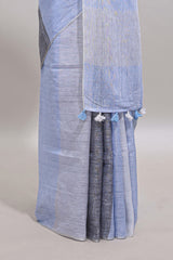 Light sky blue south cotton saree body with broad grey contrast borders and a matching striped pallu finished with tassels with a matching blouse piece