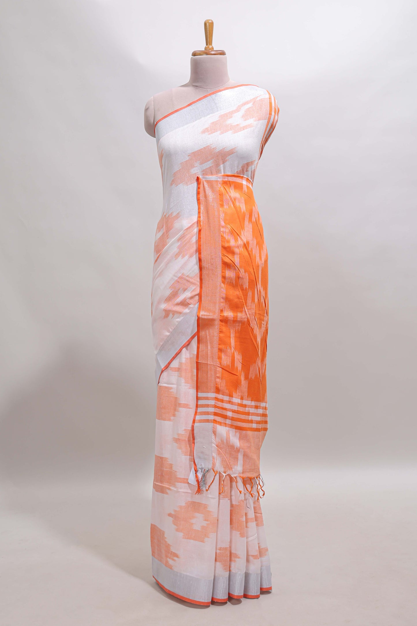 White ikkat style motifs south cotton saree with contrast silver zari border and blouse