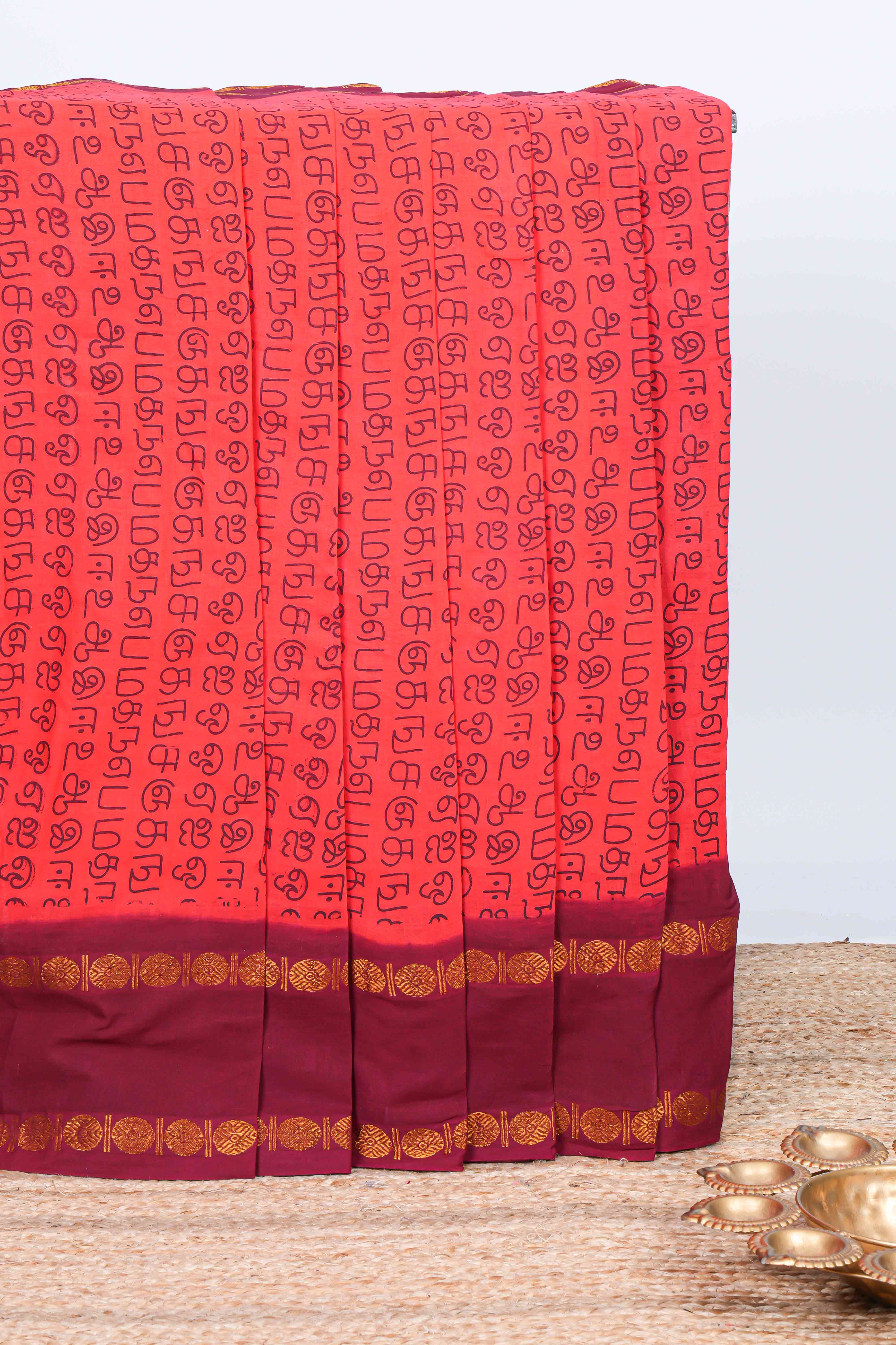 Pink tamil script print sungudi cotton saree with contrast zari bentex border and pallu