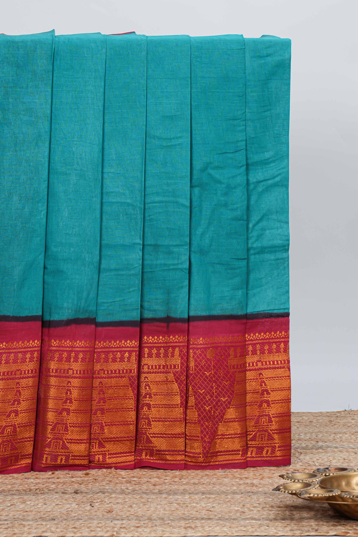 Elegant turquoise blue Sungudi cotton saree with contrast temple inspired pattern border and contrast pallu along with matching blouse