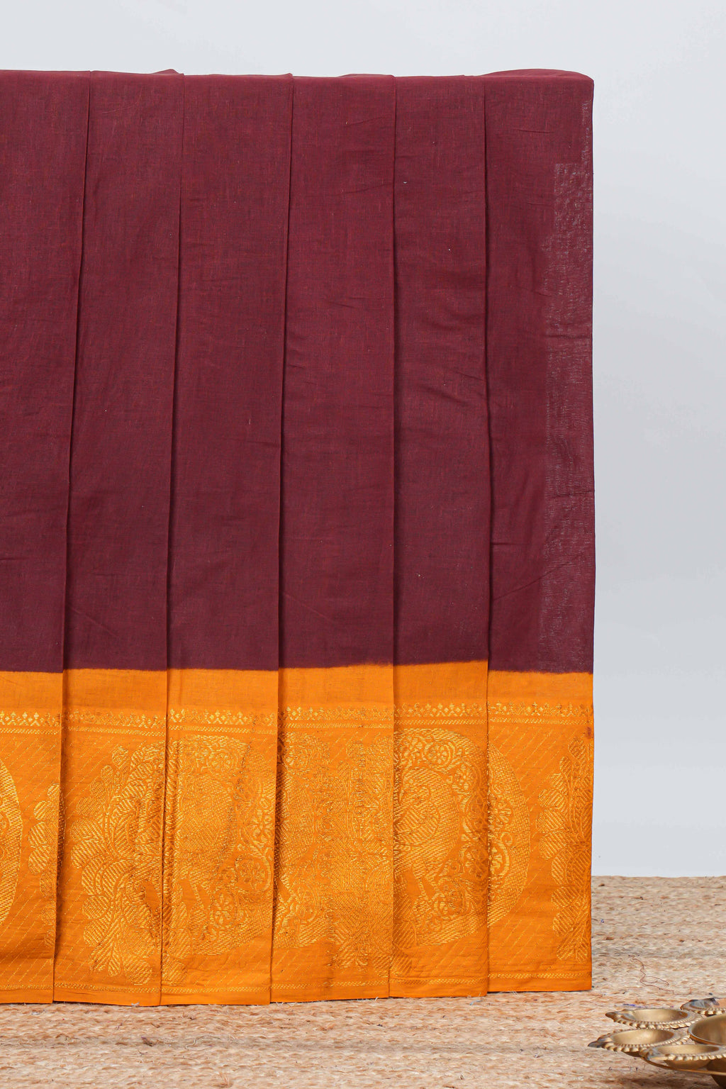 Elegant maroon Sungudi cotton saree with contrast temple inspired pattern border and contrast pallu along with matching blouse