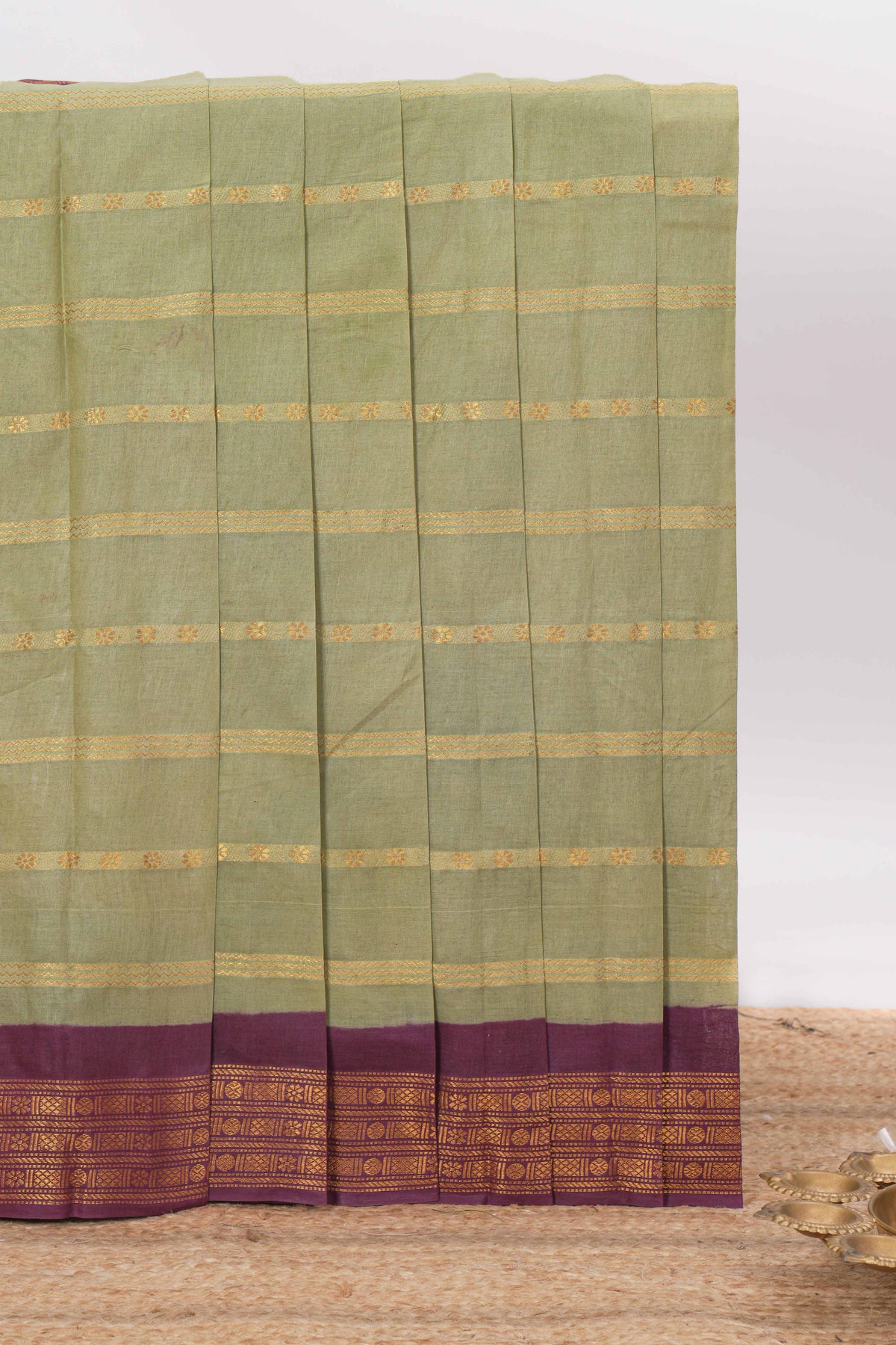 Pastel green Sungudi cotton saree with gold zari stripe motifs a contrasting  zari border checked pallu and contrast blouse