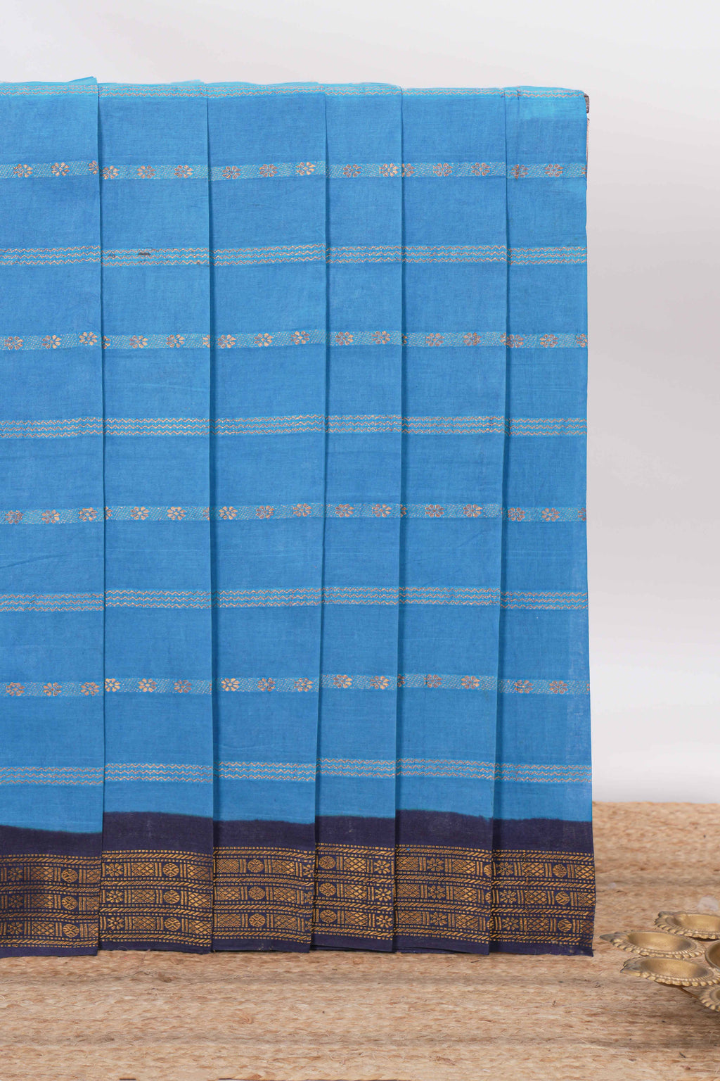 Blue Sungudi cotton saree with gold zari stripe motifs a contrasting  zari border checked pallu and contrast blouse