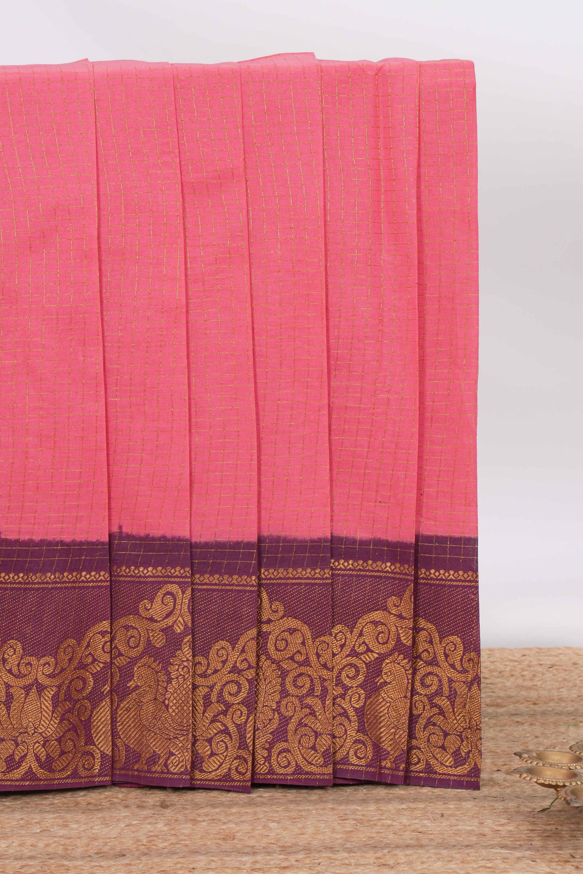 Pink sungudi cotton saree with checked body contrasting peacock zari border striped pallu and a matching checked blouse