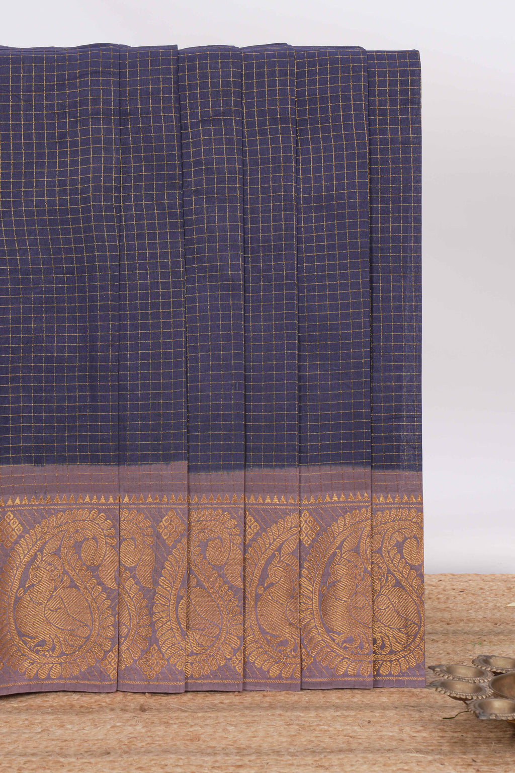 Navy blue sungudi cotton saree with checked body contrasting peacock zari border striped pallu and a matching checked blouse