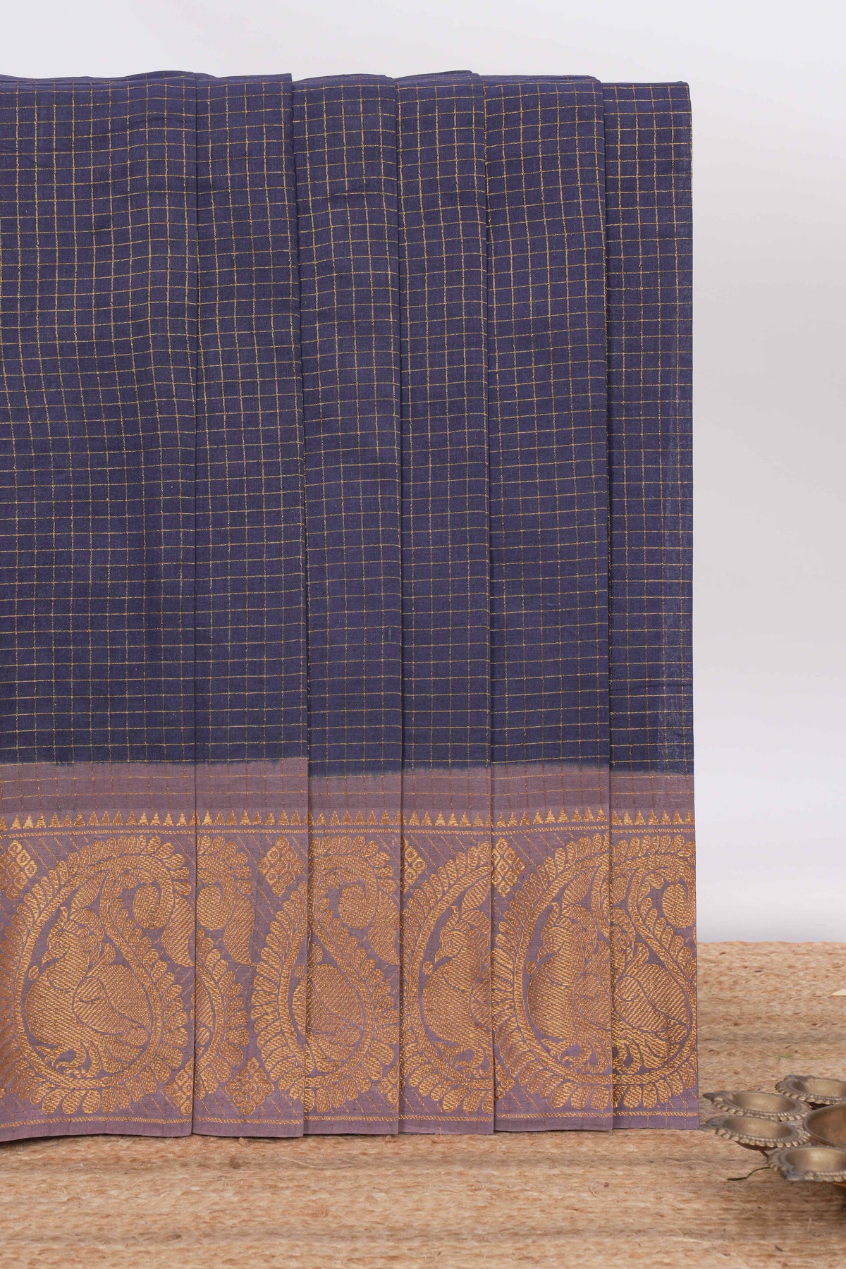 Navy blue sungudi cotton saree with checked body contrasting peacock zari border striped pallu and a matching checked blouse