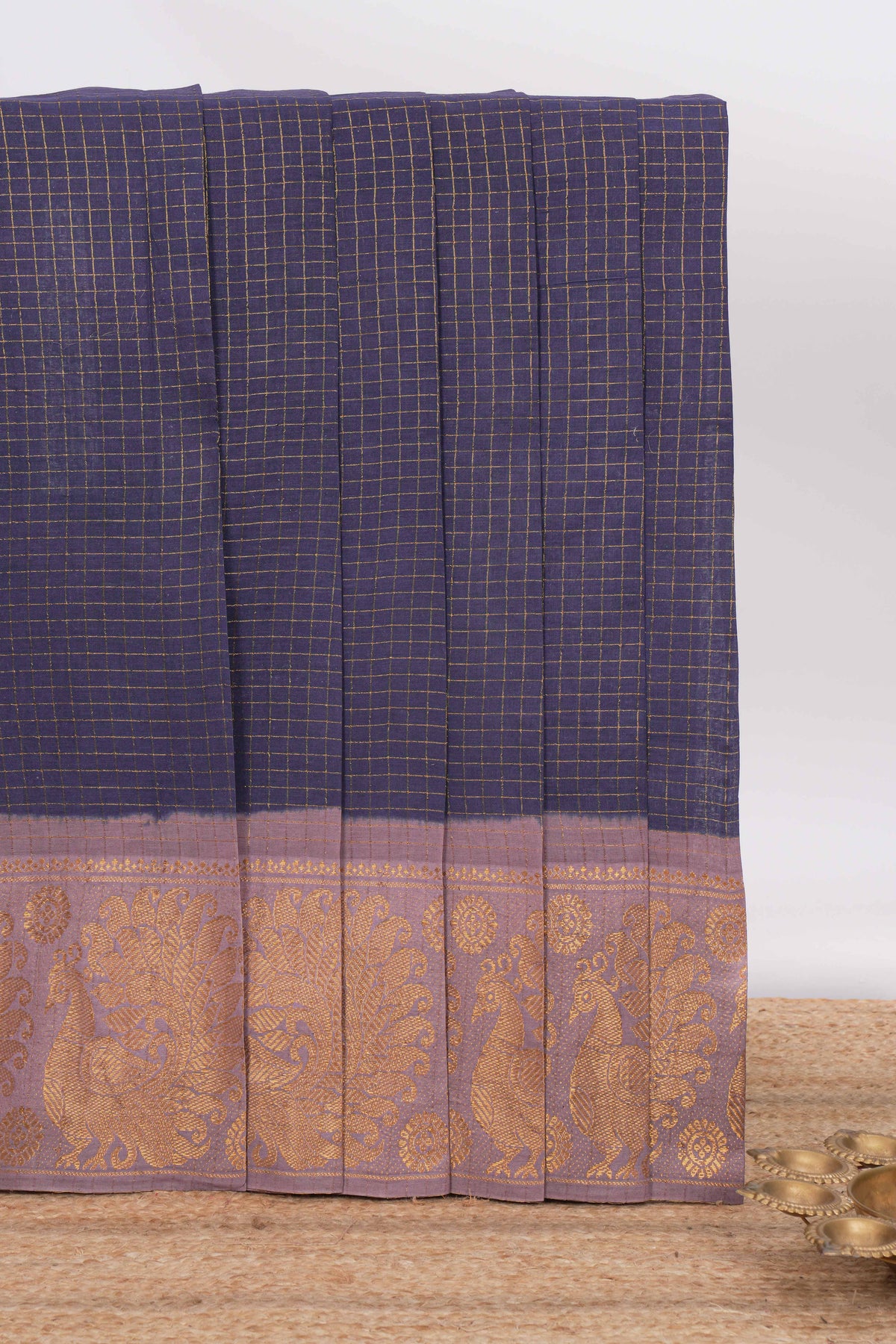 Dark blue sungudi cotton saree with checked body contrasting peacock zari border striped pallu and blouse