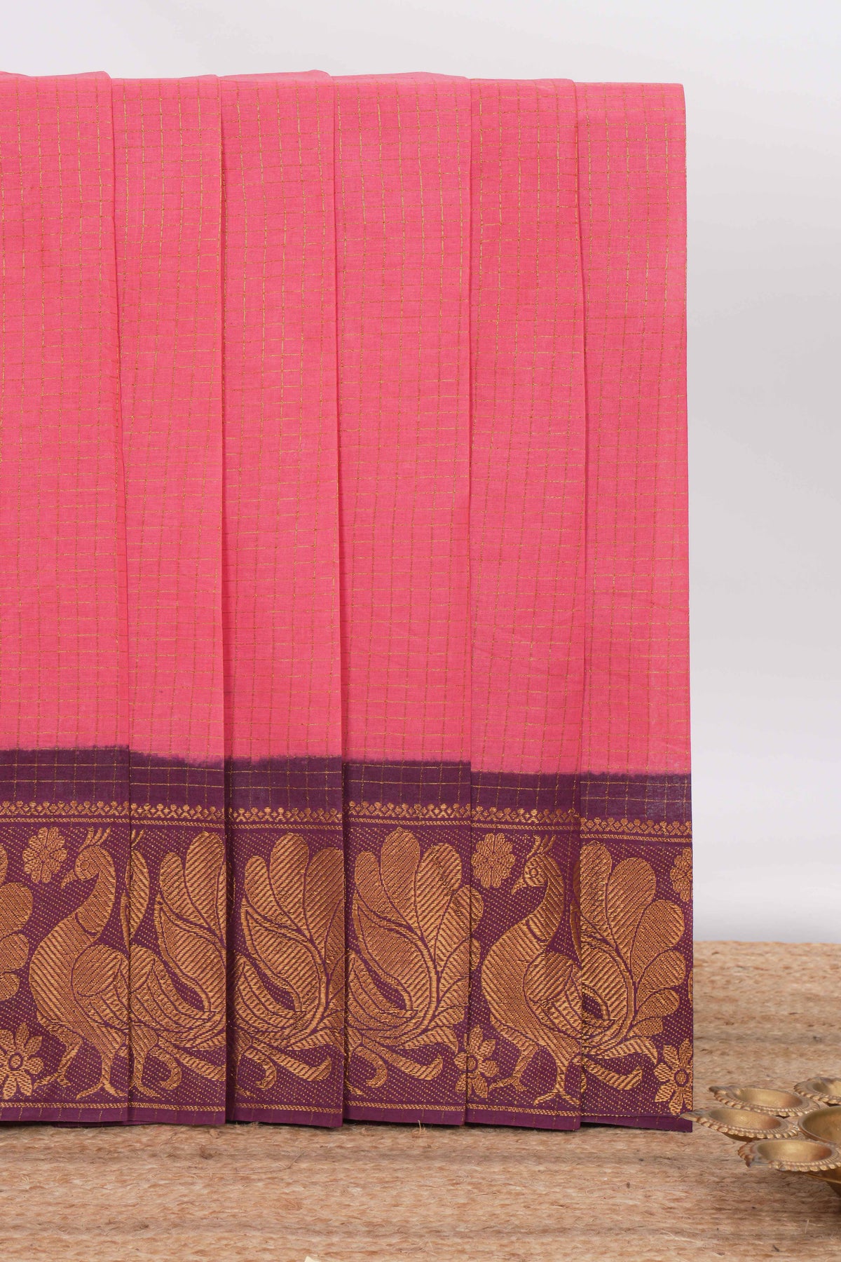 Bright pink sungudi cotton saree with checked body contrasting peacock zari border striped pallu and blouse