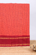 Peach tamil letters print sungudi cotton saree with contrast border and striped pallu