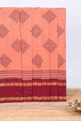 Peach traditional kolam print sungudi cotton saree with contrast border and striped pallu