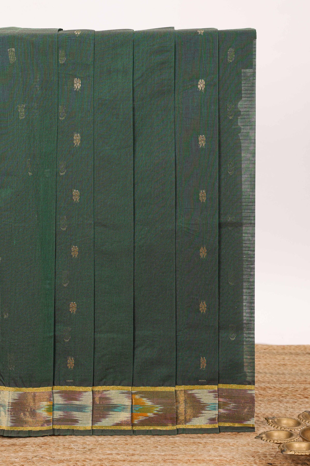 Dark green butta designed silk cotton saree with self zari border and contrast blouse