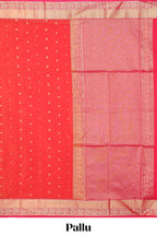 Coral red butta designed silk cotton saree with self zari border and contrast blouse