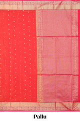 Coral red butta designed silk cotton saree with self zari border and contrast blouse