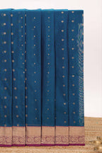 Blue butta designed silk cotton saree with contrast zari border and contrast blouse