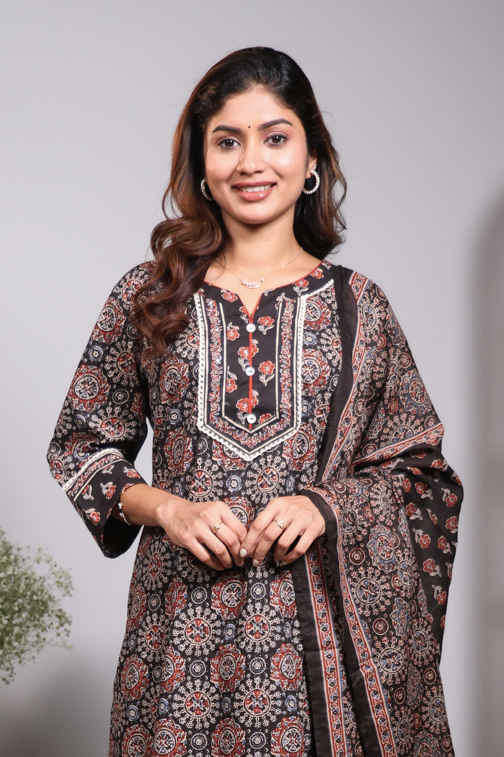 Black floral design round neck salwar set with 3/4th sleeve, self bottom and matching dupatta