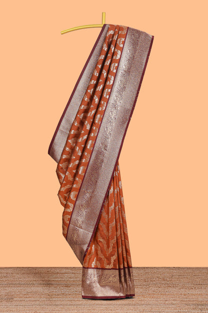 Brown zig zag zari design semi soft silk saree with contrast border and floral printed blouse