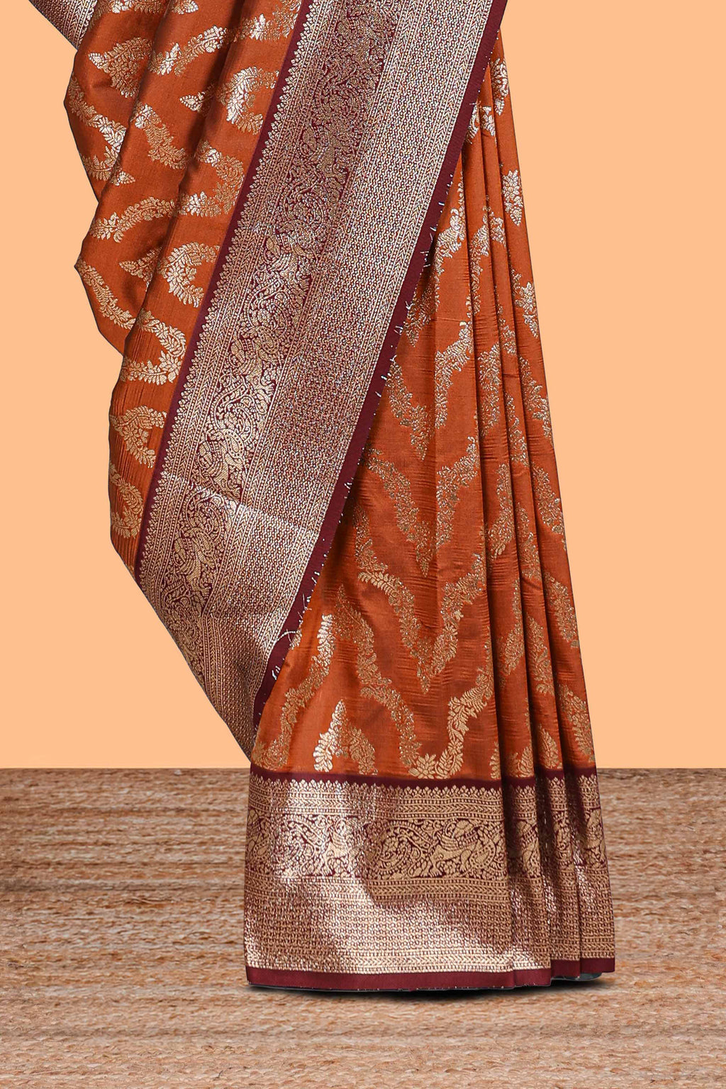 Brown zig zag zari design semi soft silk saree with contrast border and floral printed blouse