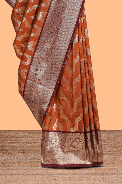 Brown zig zag zari design semi soft silk saree with contrast border and floral printed blouse