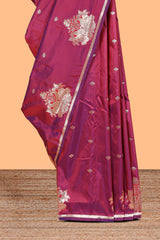 Magenta colour Semi soft silk withgold zari floral motifs border with peacock motifs and matching blouse