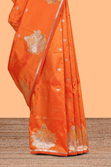 Orange colour Semi soft silk withgold zari floral motifs border with peacock motifs and matching blouse