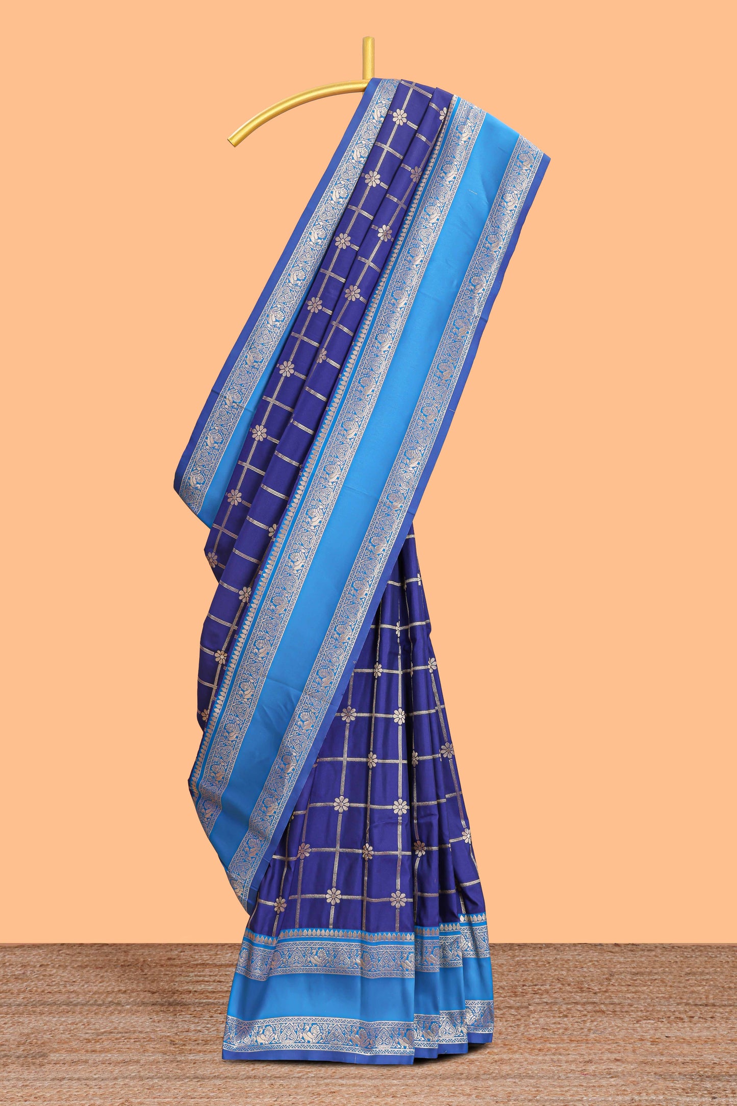 Blue checked floral zari design semi soft silk saree with contrast bentex border and floral motifs blouse