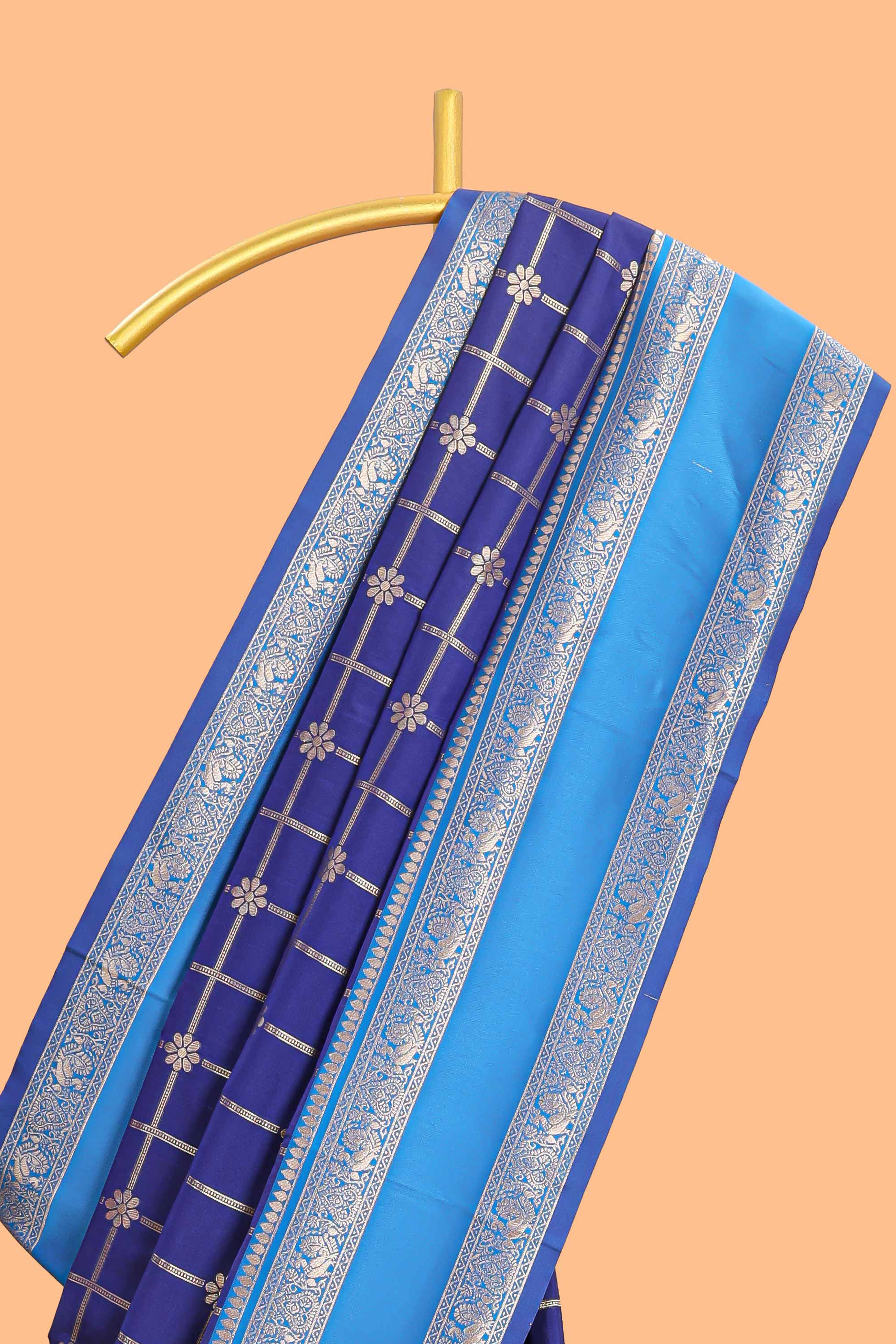 Blue checked floral zari design semi soft silk saree with contrast bentex border and floral motifs blouse