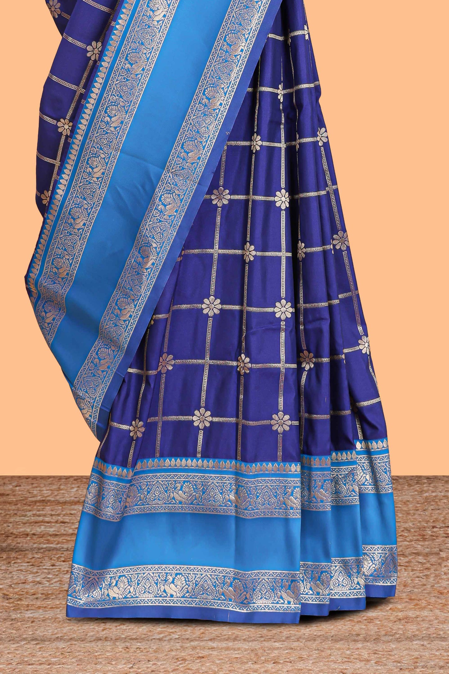 Blue checked floral zari design semi soft silk saree with contrast bentex border and floral motifs blouse