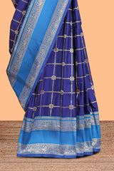 Blue checked floral zari design semi soft silk saree with contrast bentex border and floral motifs blouse