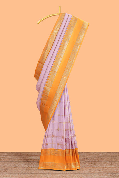 Pale lavender checked floral zari design semi soft silk saree with contrast bentex border and floral motifs blouse