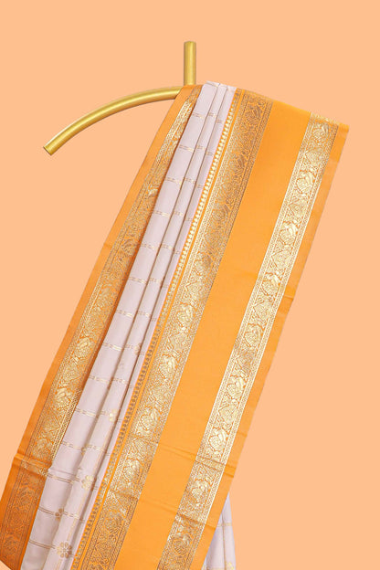 Cream checked floral zari design semi soft silk saree with contrast bentex border and floral motifs blouse