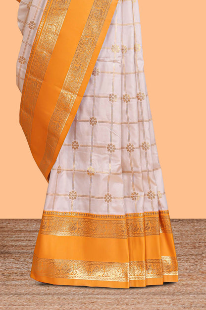 Cream checked floral zari design semi soft silk saree with contrast bentex border and floral motifs blouse
